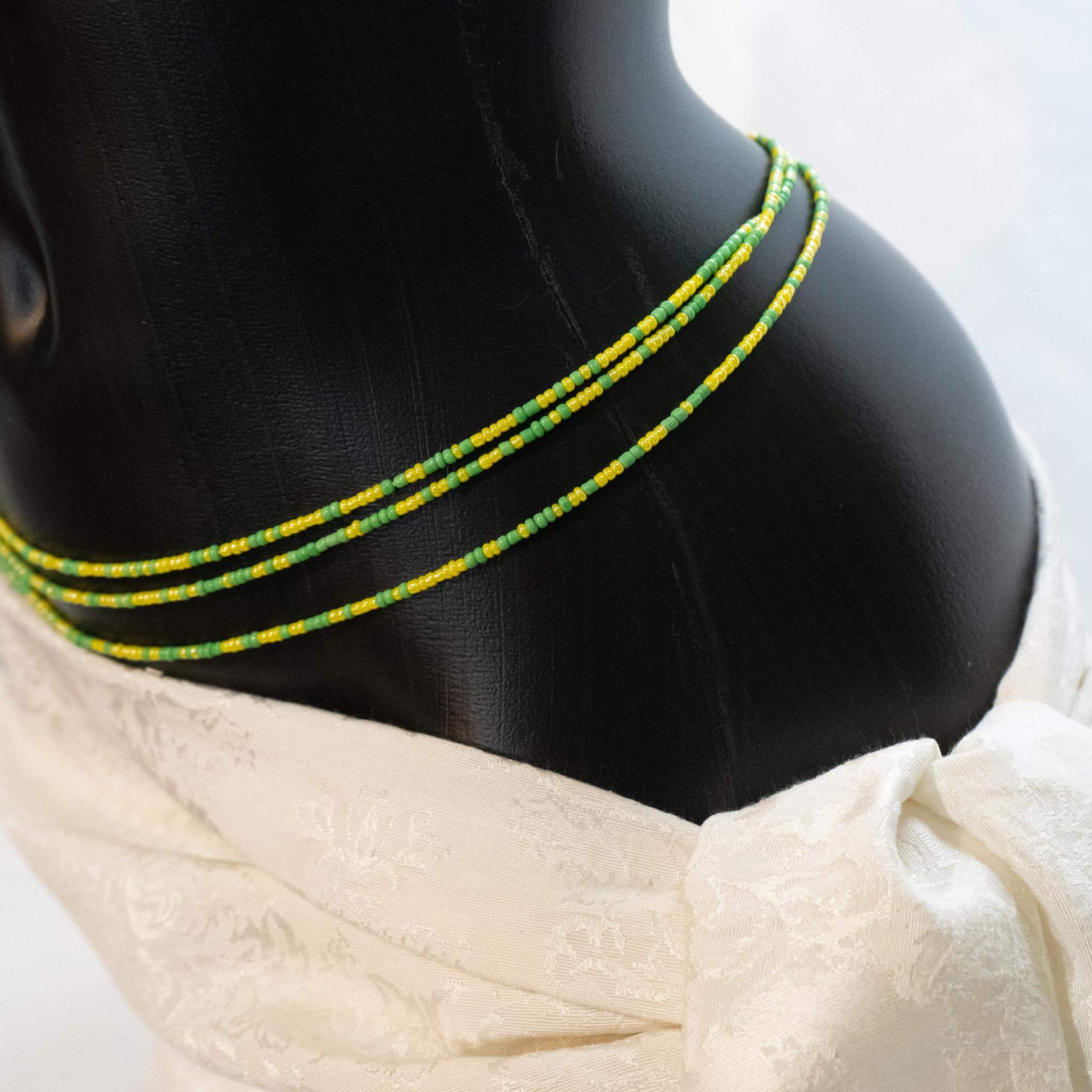 AfroBeads Waist Beads in Spring Green and Maize Yellow Seeds  Tilted View