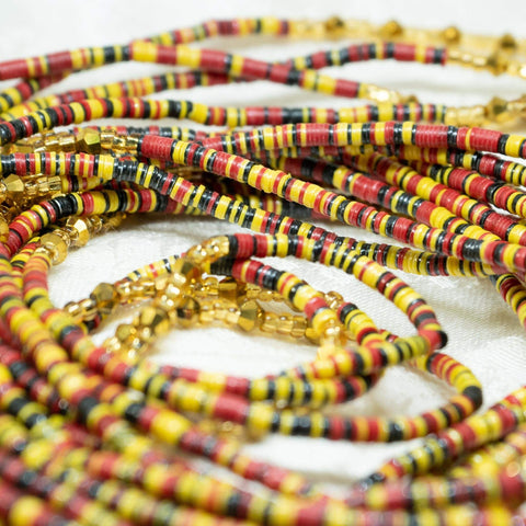 AfroBeads Waist Beads in Barn Red, Sun Glow Yellow Seeds, and Crystal Gold  Close Up